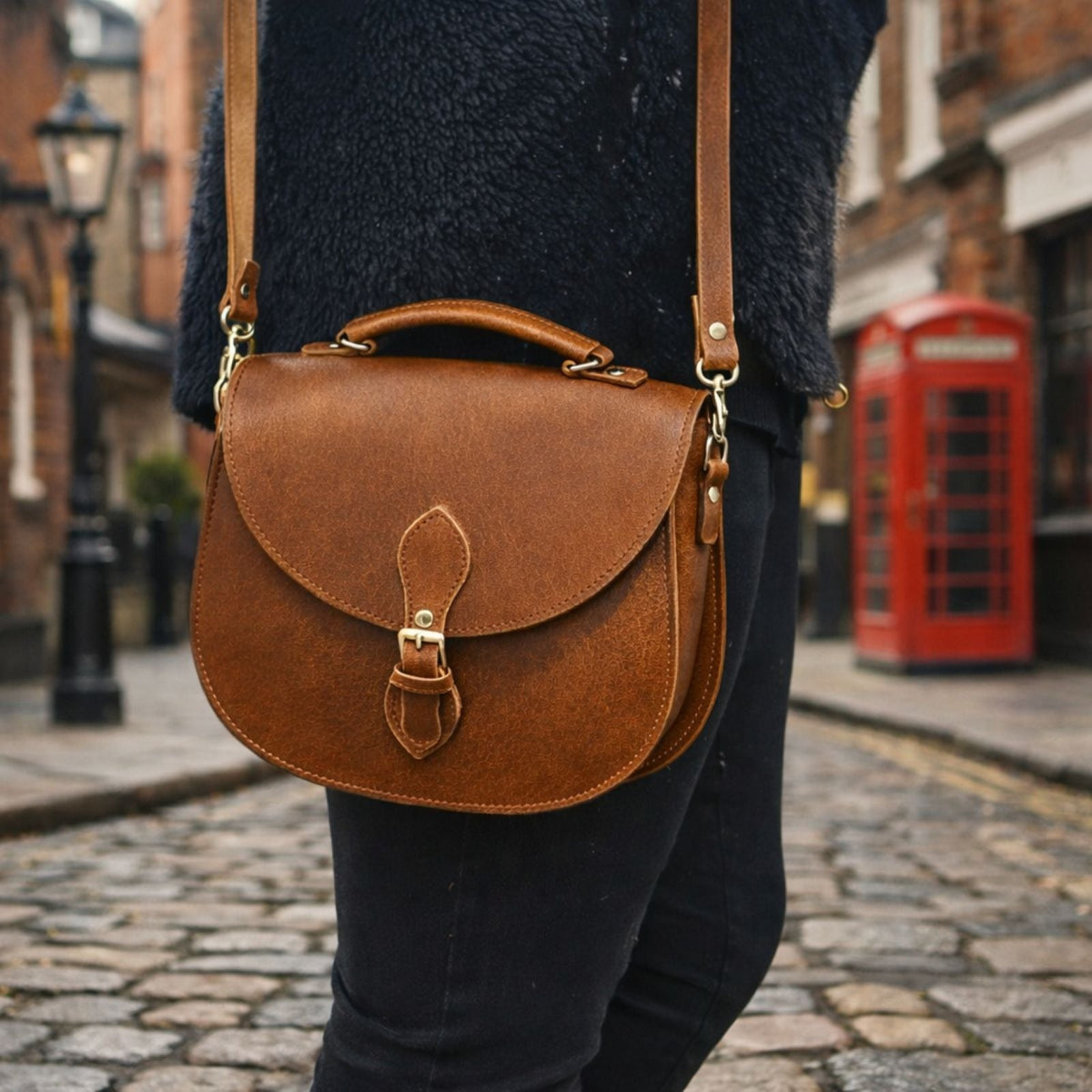 Zatchels Tannery Leather Saddle Bag in Tan, shown worn by a model